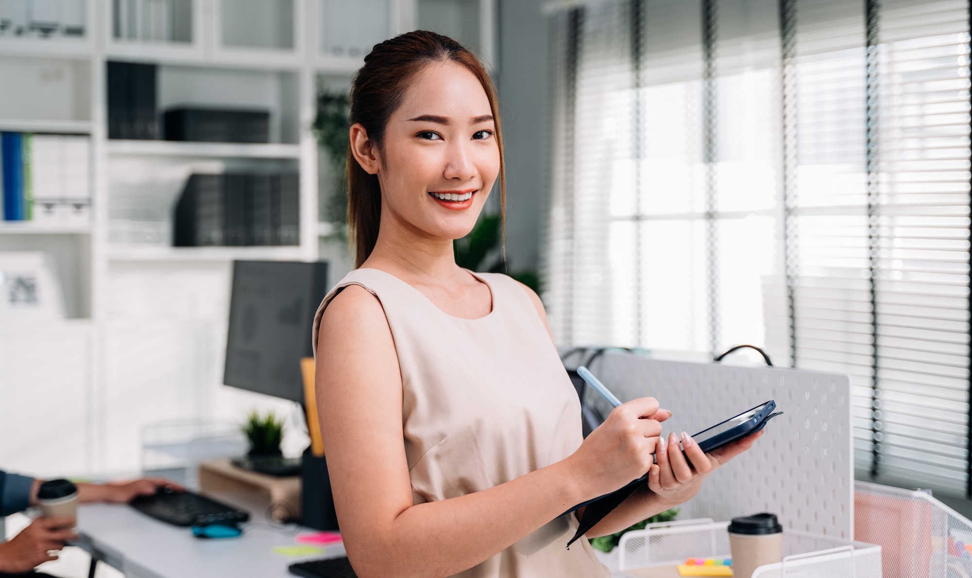 Portrait of businesswoman looking camera with smile at modern office